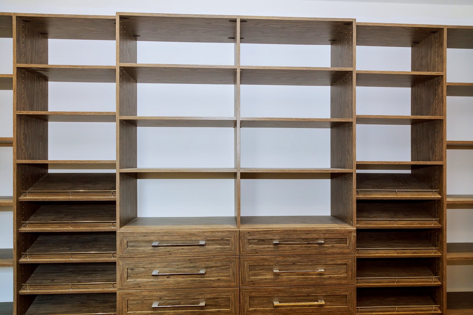 Huge closet with shelves, drawers and shoe racks with wooden shelves wall installing a shelf